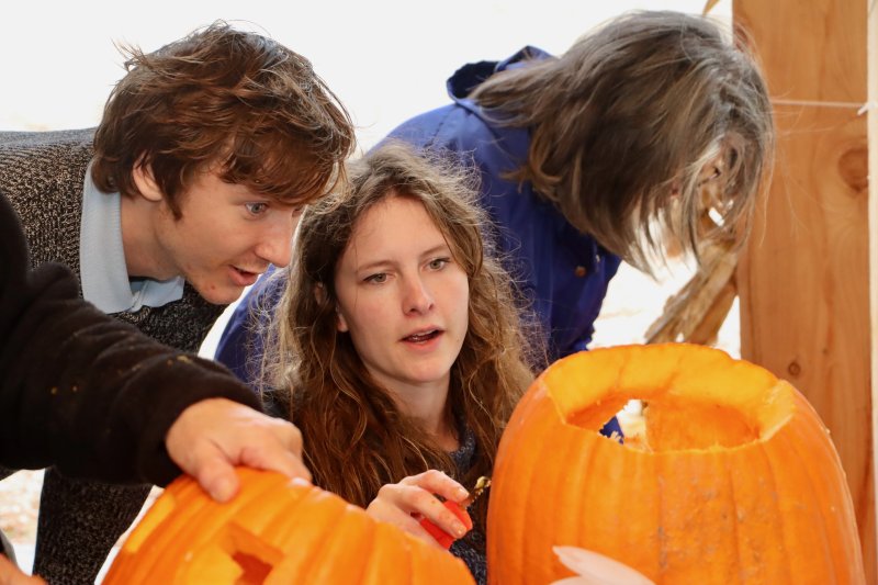 Dawson Gehrke, assistant director of education for Historic Lewes, left, and Lucia Gehrke inspect their carved pumpkin.